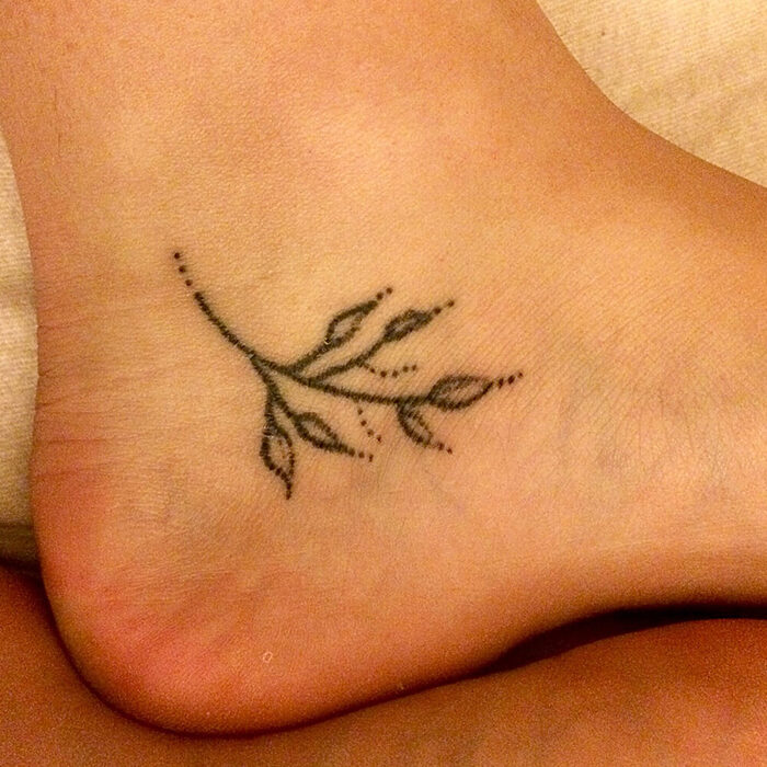 Stick and poke tattoo of flower buds