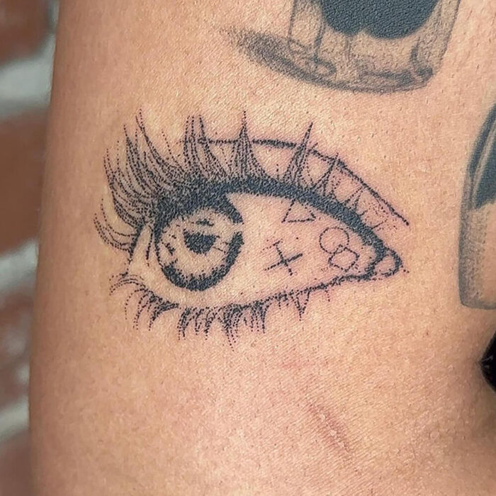 Stick and poke tattoo of an eye