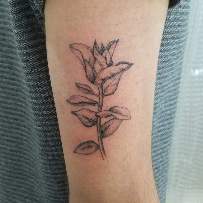 Stick and poke tattoo of a flower