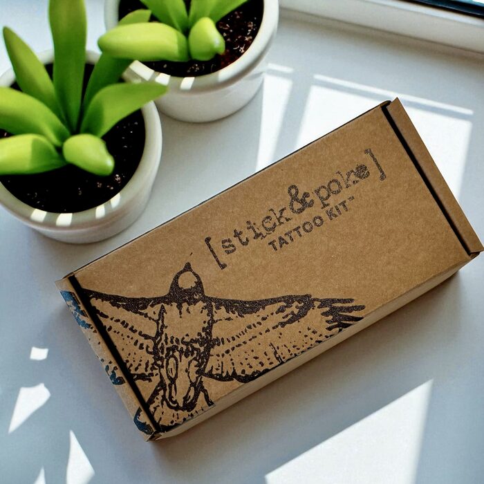 Hand poke tattoo kit on table